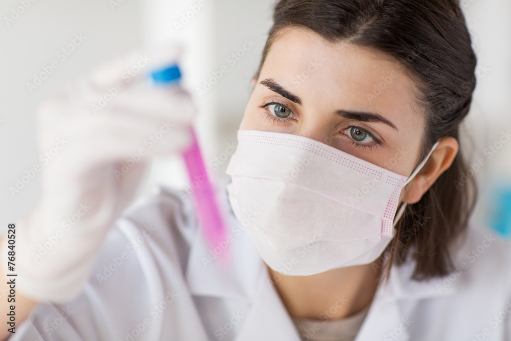 close up of scientist with tube making test in lab