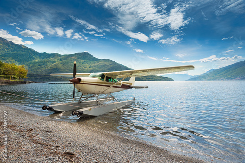 Fototapeta Naklejka Na Ścianę i Meble -  Float plane moored at a beach on Lake Como in Italy, Europe