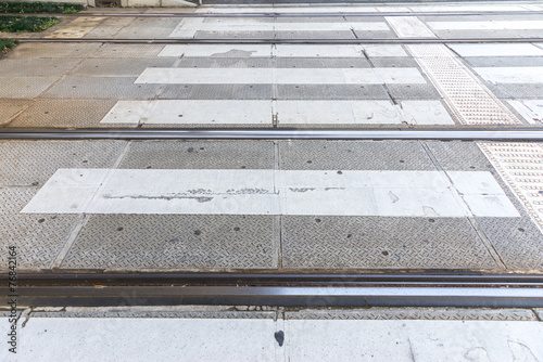 Rail of the tram lean together with crosswalk
