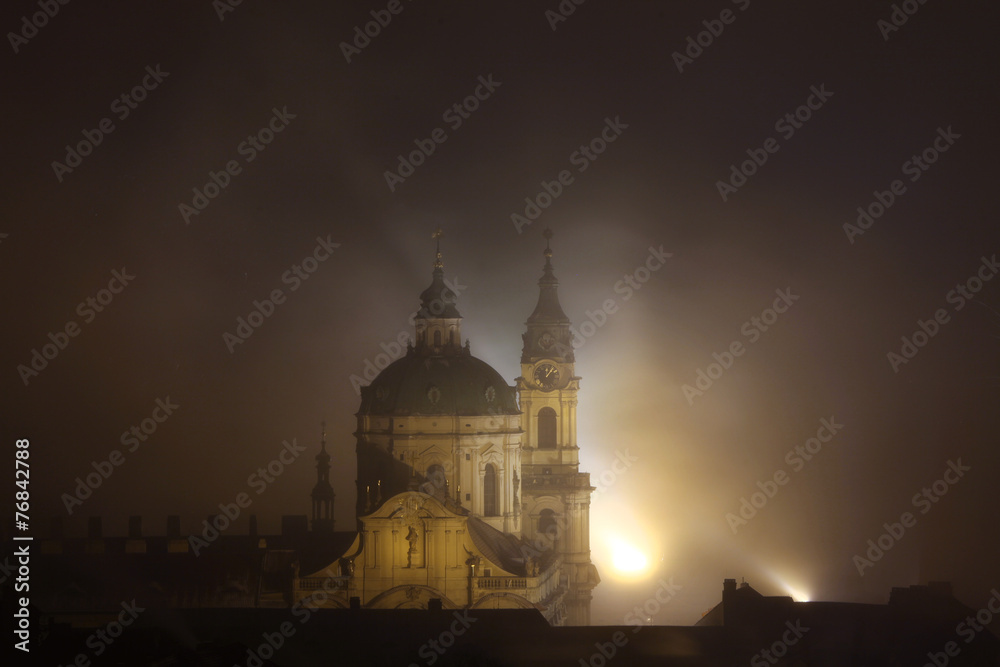 Night fog over Saint Nicholas Church in Prague, Czech Republic.
