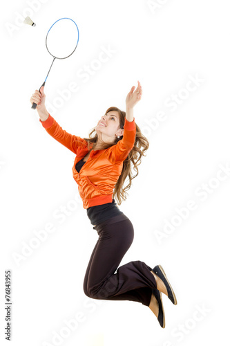 Woman jumping with racket for badminton catching shuttlecock © feelphotoartzm