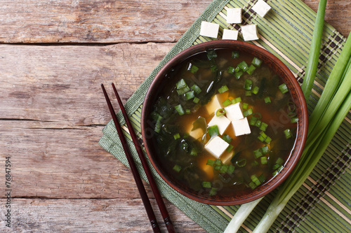 Japanese miso soup in a brown bowl horizontal top view