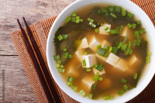 classic miso soup in a white bowl close-up horizontal top view