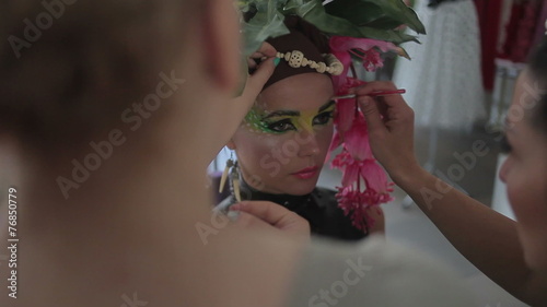 Visagiste makes makeup for  model, professional makeup artist