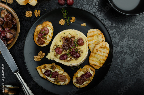 Brie cheese baked with nuts and grapes