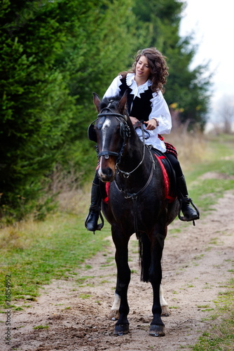 young woman riding horse outdoor