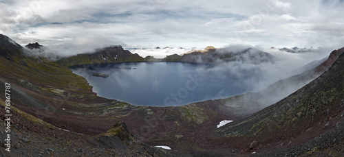 Panoramic view of crater lake active Khangar Volcano. Kamchatka