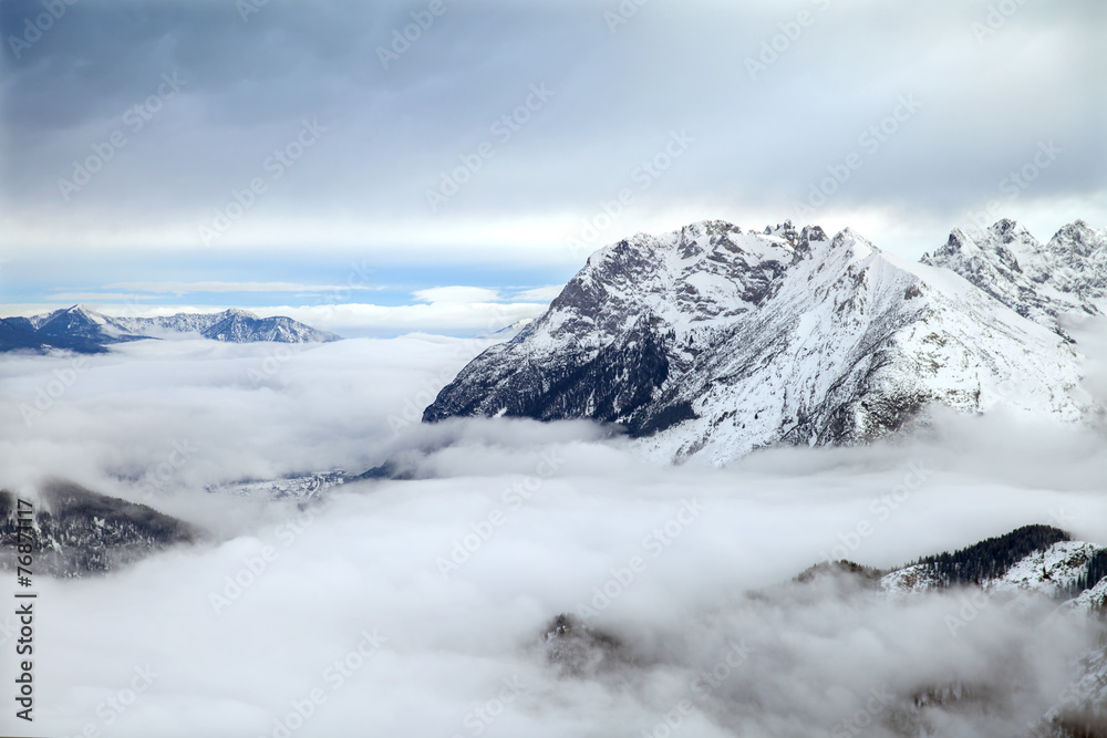 The low clouds over high mountains in winter day