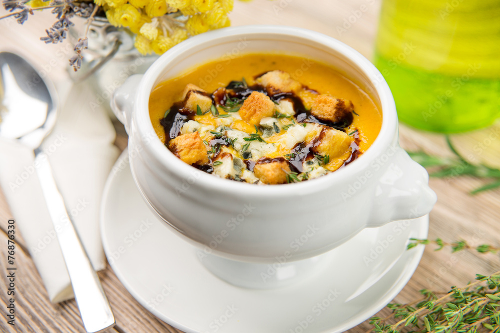 Pumpkin soup with croutons on wooden table Pumpkin soup with croutons on wooden table