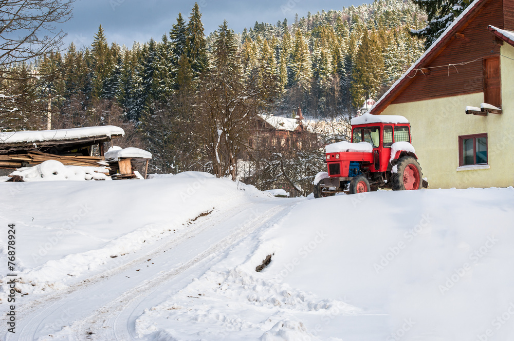 Naklejka premium farm tractor in snow