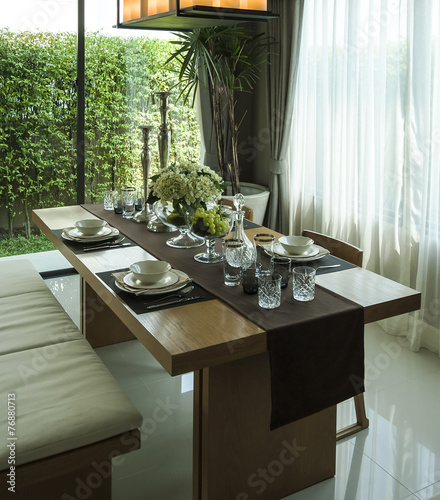 dining table and comfortable chairs in modern home with elegant