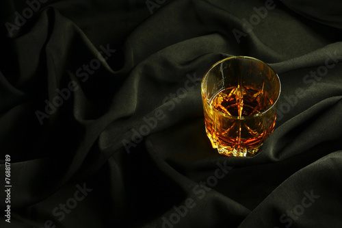 Whiskey on black cloth photo