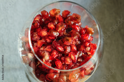 Pomegranate seeds in a glass of wine.