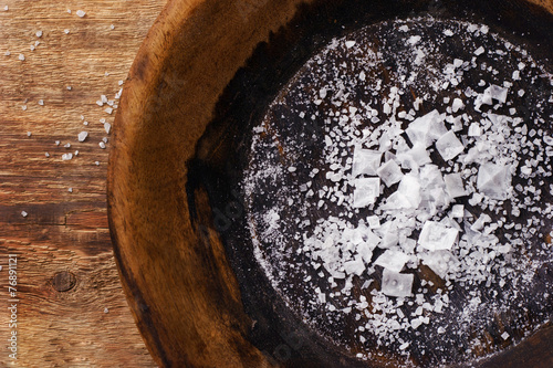 Various sea salt on the vintage wooden plate