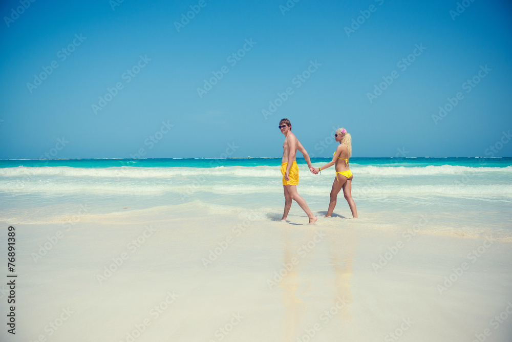 Young couple walking along the seashore