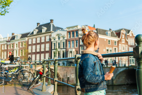 Photography Cute little girl looking on a beautiful canal in Amsterdam