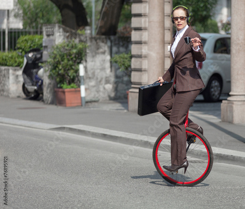 portrait of businesswoman with unicycle photo