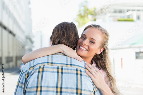 Attractive couple standing and hugging