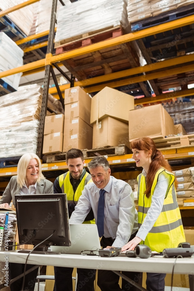 Warehouse team working together on laptop Warehouse team working together on laptop