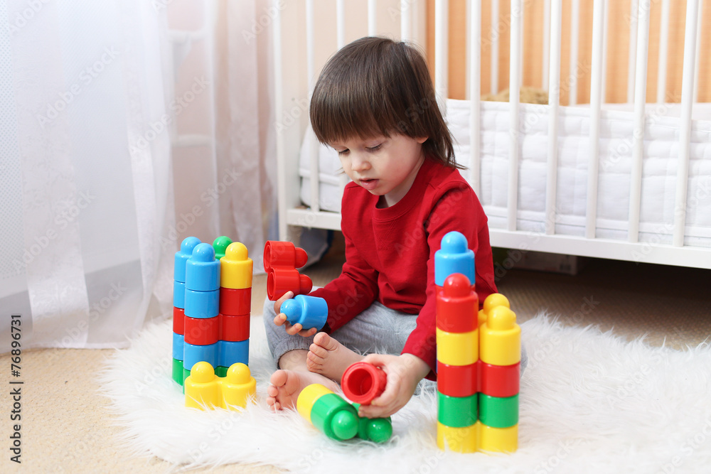 Lovely 2 years toddler playing plastic blocks Lovely 2 years toddler playing plastic blocks