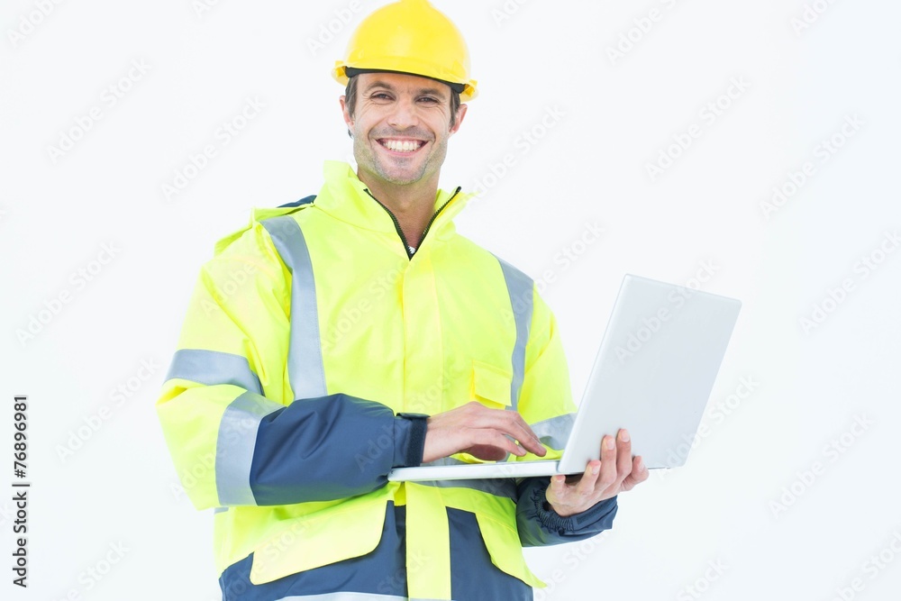 Male architect in reflective clothing using laptop Male architect in reflective clothing using laptop