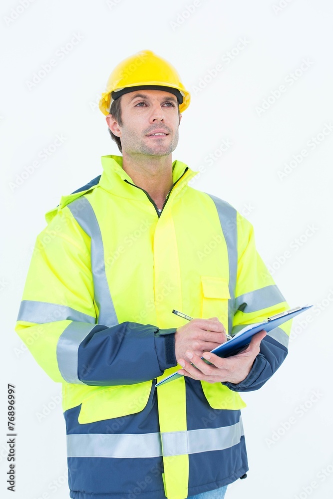 Male architect writing on clipboard Male architect writing on clipboard