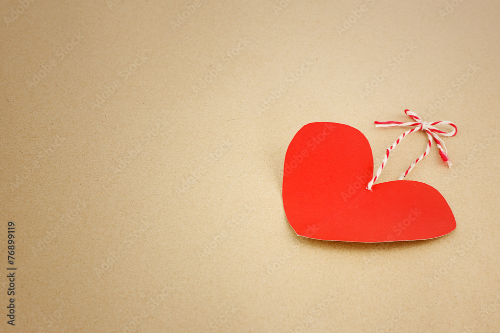 Fototapeta premium Red heart on brown as valentines background