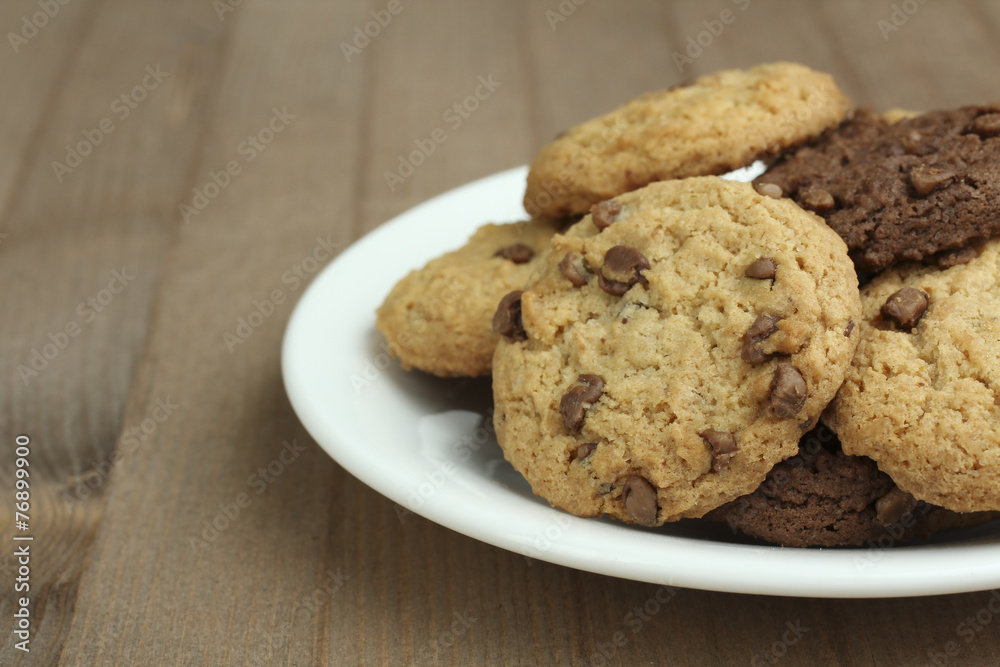 chocolate chip cookies on a plate on a wooden background