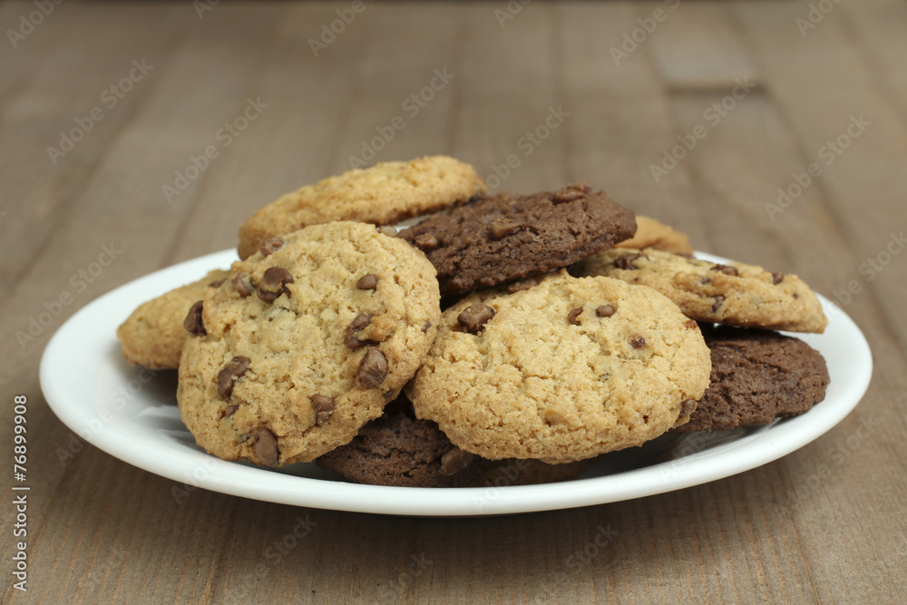 chocolate chip cookies on a plate on a wooden background chocolate chip cookies on a plate on a wooden background