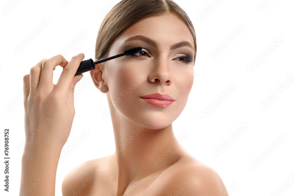 woman with brush for eyelashes