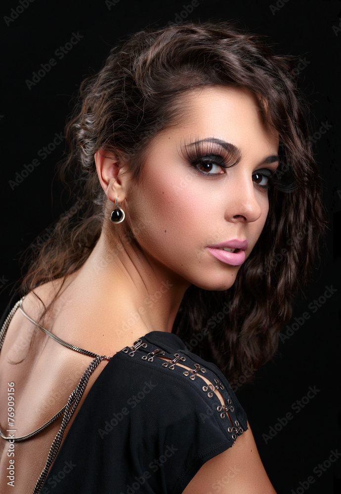Beautiful woman in sexy evening dress against dark background. Beautiful woman in sexy evening dress against dark background.