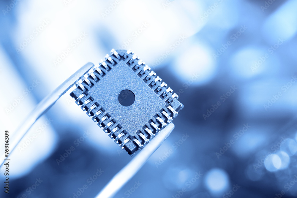 Fototapeta premium computer chip with tweezers, electronic