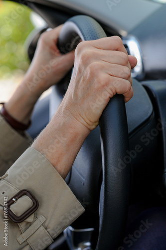 Senior woman hand on steering wheel © FreeProd