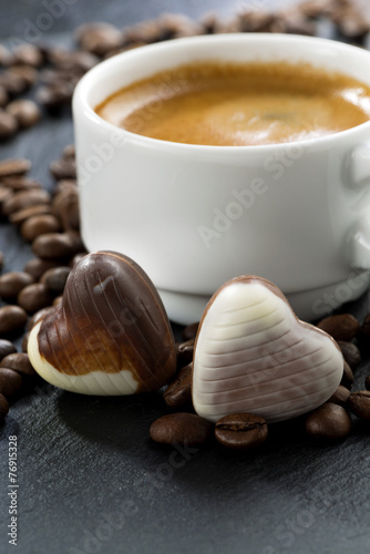 espresso, coffee beans and chocolate candies in a heart shape