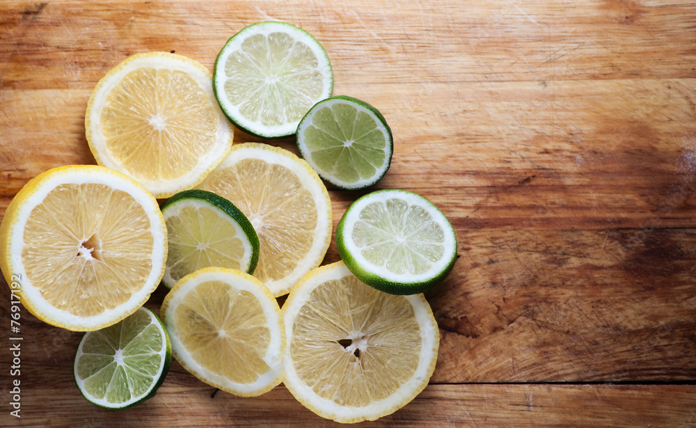 Lemon and limes on rustic wood Lemon and limes on rustic wood