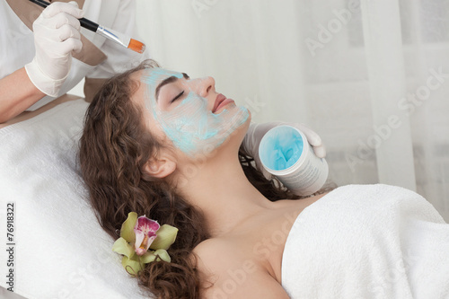 Young Beautiful Relaxing Woman Having Moistening Mask Applied