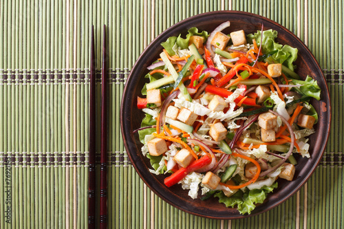 Asian salad with tofu and fresh vegetables horizontal top view
