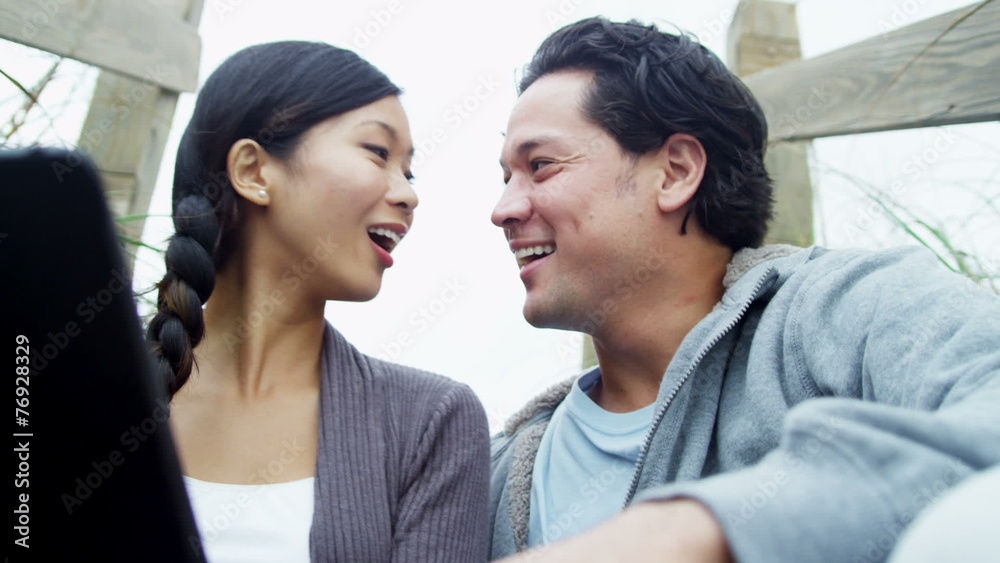 Young Ethnic Couple Together Outdoors Fall Beach Fun Tablet Young Ethnic Couple Together Outdoors Fall Beach Fun Tablet