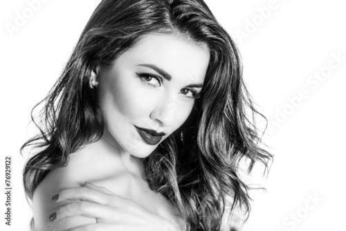 Black and white portrait of cute woman touching shoulder closeup