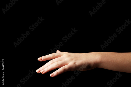 Female hand on dark background