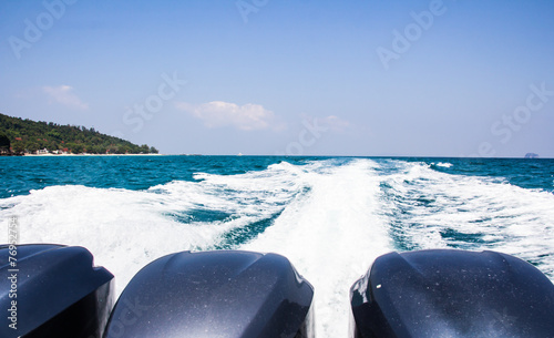 Foamy wake behind the stern of the ship photo