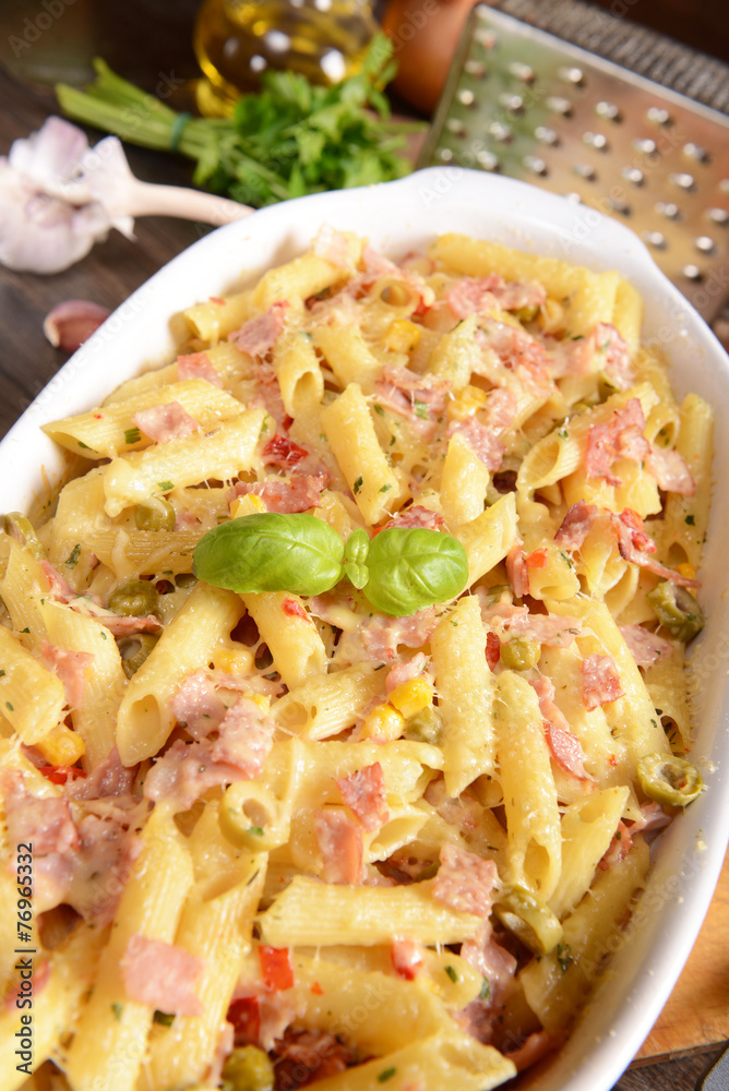Fototapeta premium Penne pasta casserole with cheese, ham and corn
