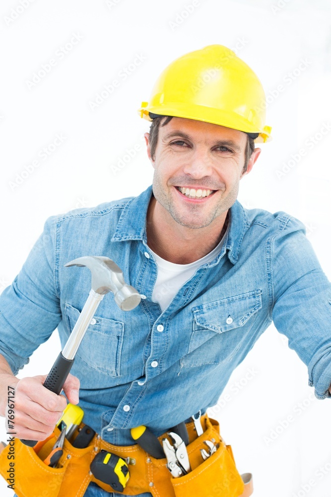 Confident carpenter using hammer Confident carpenter using hammer