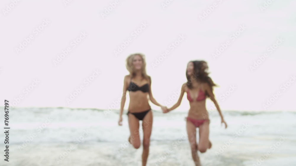Multi Ethnic Females Holding Hands Running Ocean Shallows Multi Ethnic Females Holding Hands Running Ocean Shallows