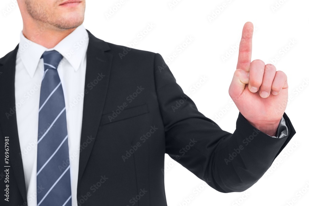 Unsmiling businessman pointing his finger