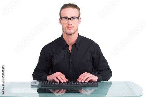 Focused businessman with reading glasses working
