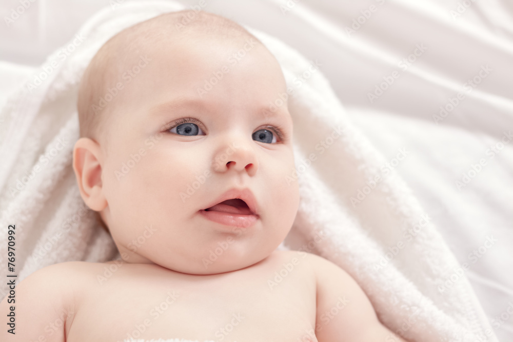 Beautiful baby relaxing in bed after bath Beautiful baby relaxing in bed after bath