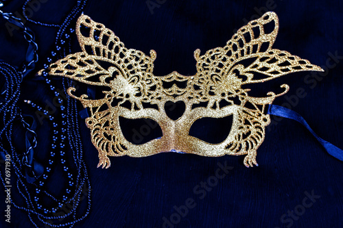 golden carnival mask on dark background
