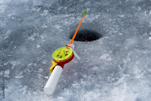 the rod for winter fishing lies near a hole