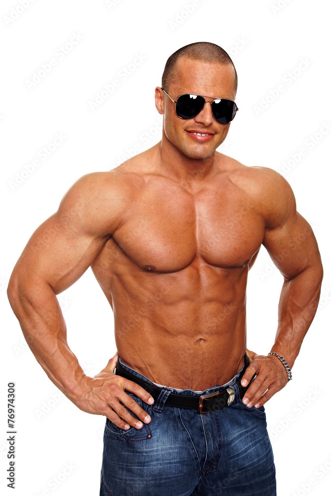 Handsome muscular man in sunglasses standing